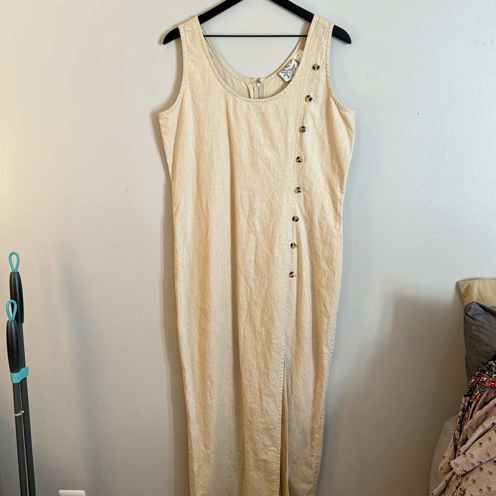 Cream colored linen dress with brown buttons and zip in back.